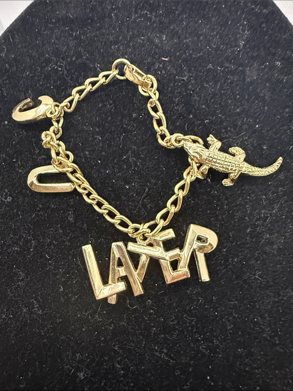 Gold tone charm bracelet  that says C U Later and an alligator